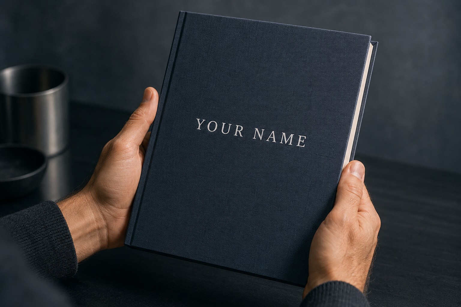 Hands holding a finished hardcover book titled Your Name