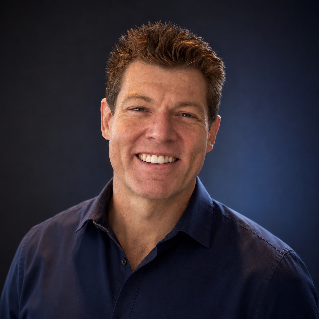 Ryan Penley smiling in a navy shirt